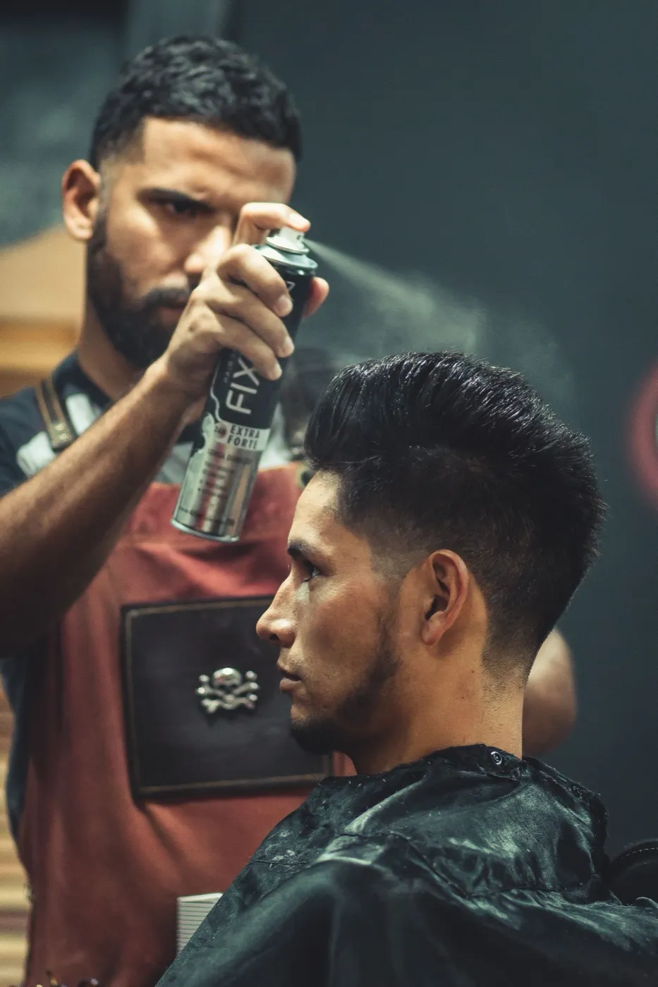 Malaysian barber cutting a client’s hair in the shop